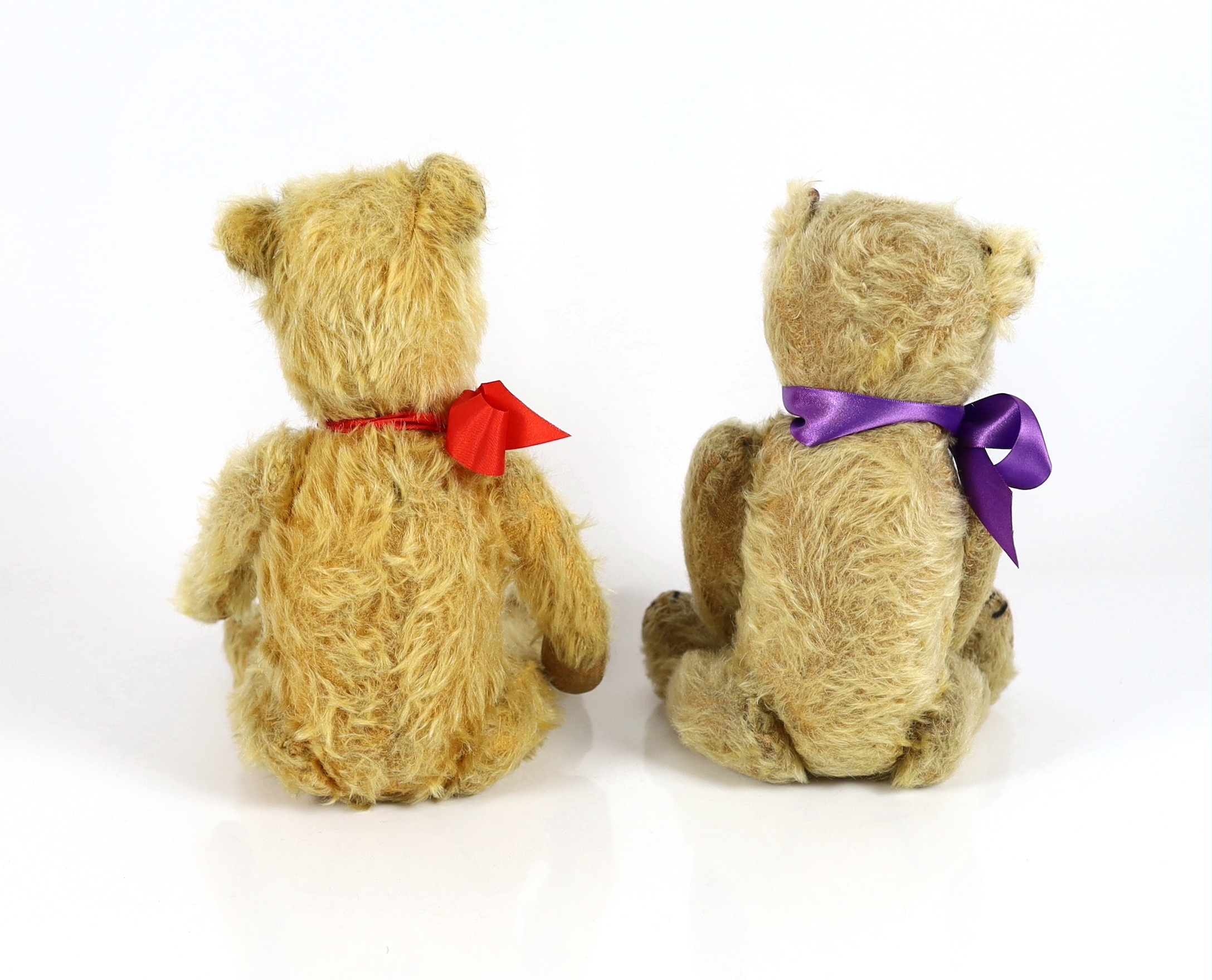 A plush covered bear with purple ribbon, 30cm and a plush covered bear with tartan ribbon, 36cm (2)